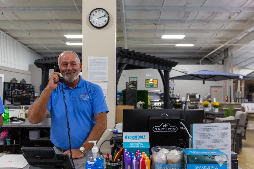 Cincinnati pool supplies specialist assisting customer at outdoor living showroom