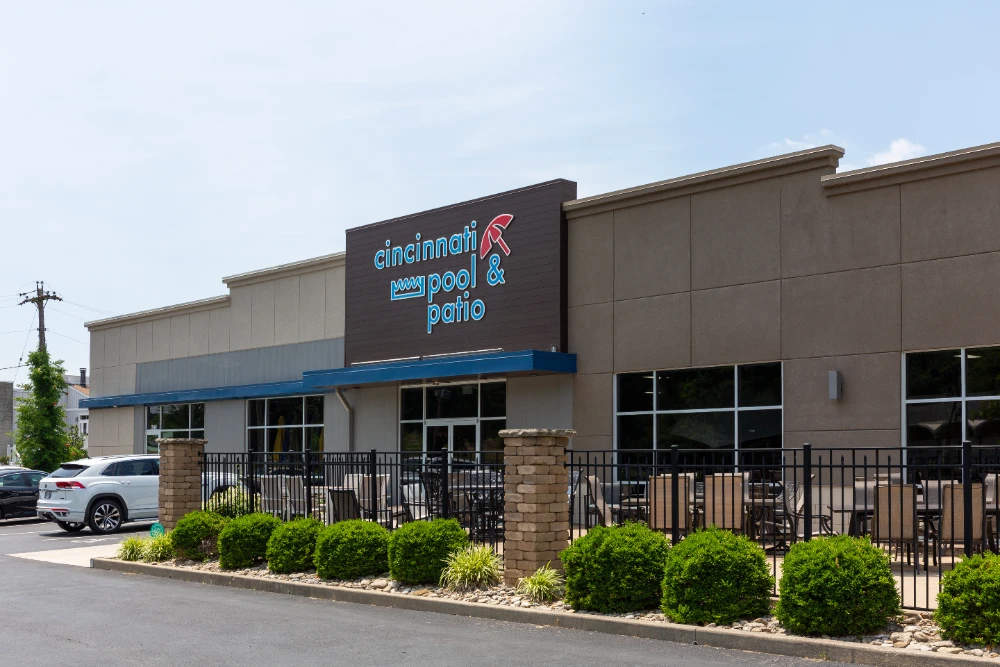Cincinnati Pool and Patio storefront with neon sign and outdoor patio seating area