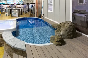 Above ground pool display with decorative rocks in Cincinnati pool showroom