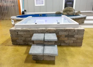 Display model hot tub with brick surround and spa hot tubs showcase in showroom