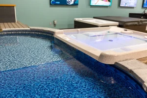 Indoor backyard pool and hot tub display with aqua water and patio furniture