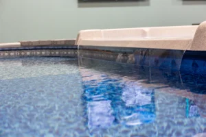 Clear blue backyard pool water with vinyl liner and deck edge visible