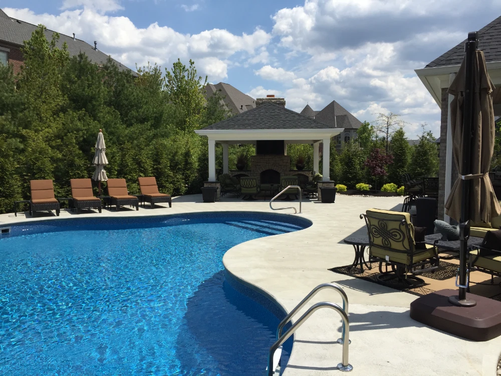 Luxurious backyard pool with patio furniture, gazebo, and outdoor living space