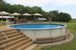 Above ground pool with wooden deck, lounge area, and outdoor patio furniture in Cincinnati backyard