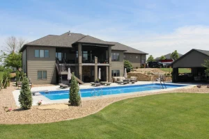 Luxurious backyard with in-ground swimming pool, patio furniture, and modern outdoor living space