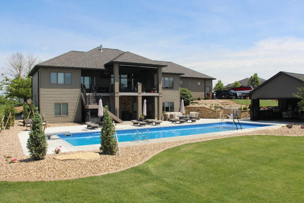 Luxurious backyard with in-ground swimming pool, patio furniture, and modern outdoor living space