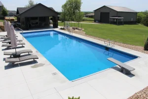 Modern backyard pool with loungers and outdoor patio furniture in Cincinnati