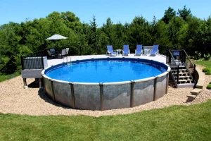 Large above ground pool with blue liner, patio furniture, and wooded backyard setting