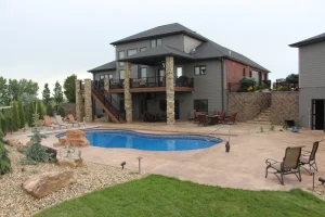 Luxurious backyard with inground pool, stone patio, and outdoor living space