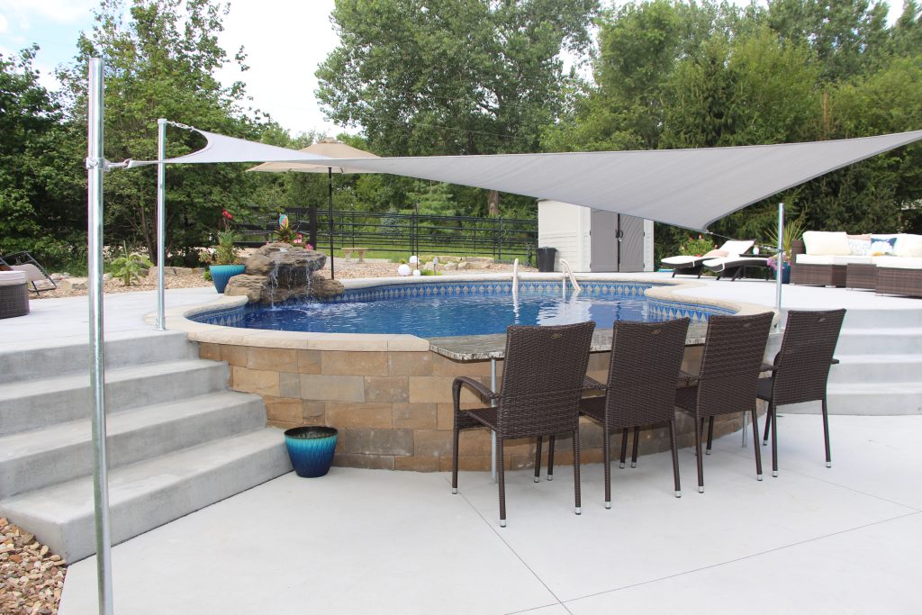Semi-inground pool with deck on a sloped Cincinnati yard