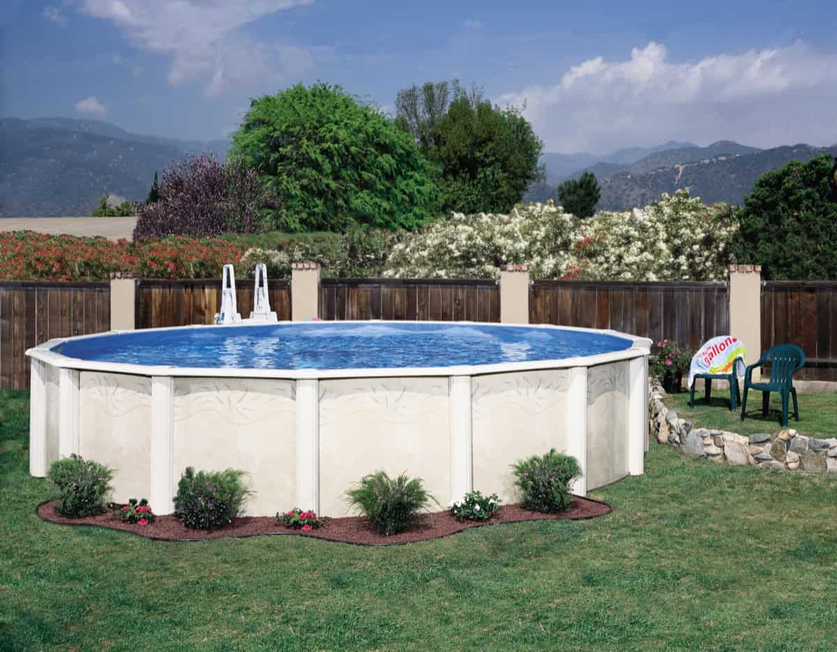 Doughboy Desert Spring above ground pool with curved resin frame installed in a backyard