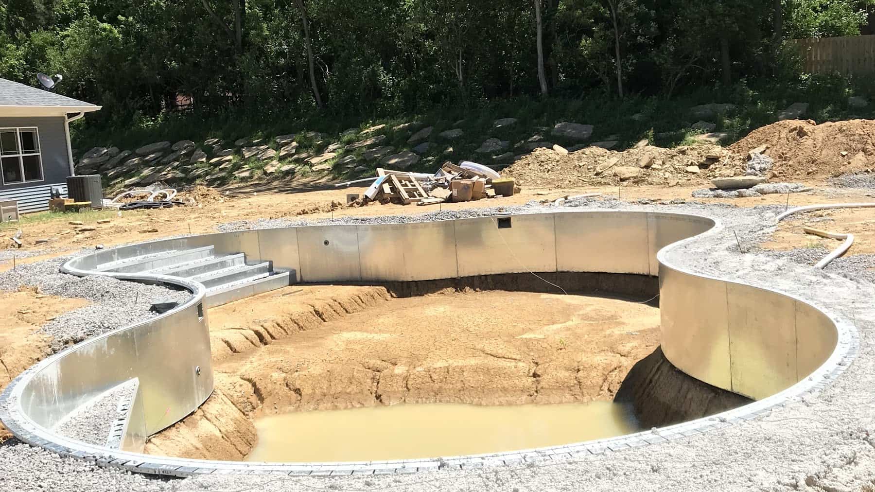 Steel wall panels and graded sand base of an inground vinyl liner pool during construction by Cincinnati Pool and Patio in Greater Cincinnati